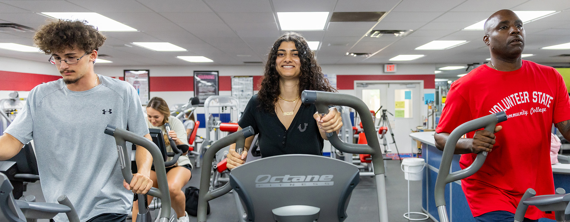 students exercising in the college's gym