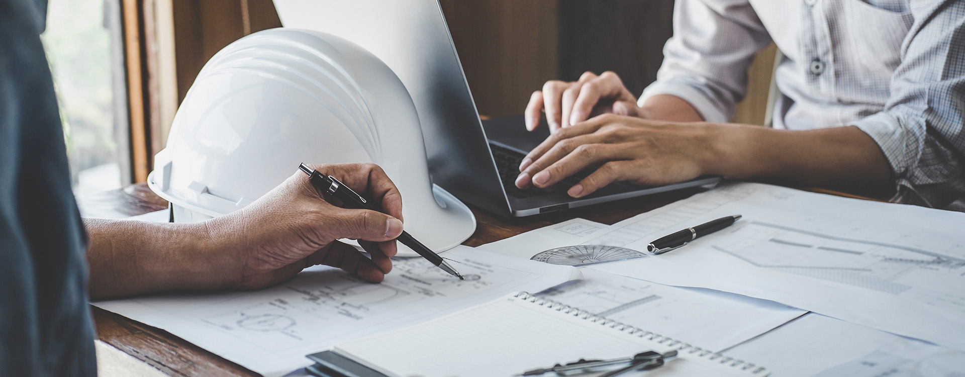 two construction contractors looking over the numbers