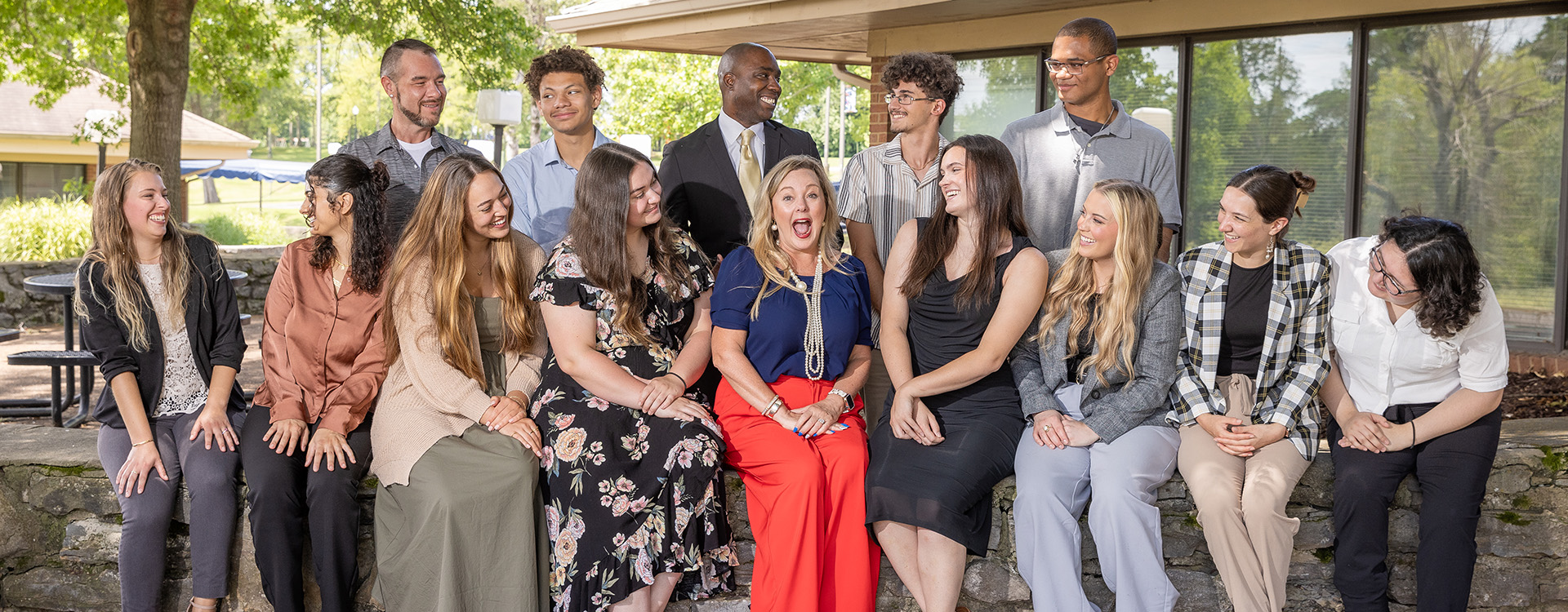 college president sitting outside with the president ambassadors