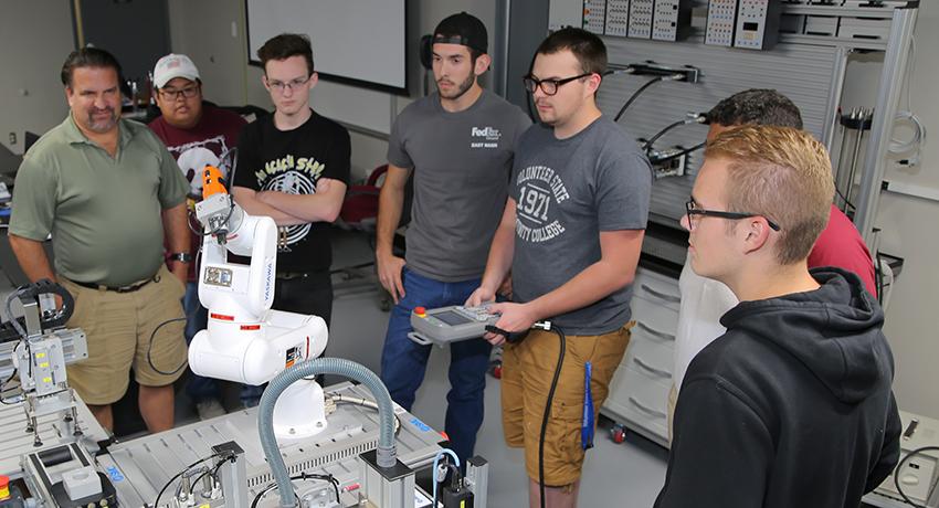 Vol State Mechatronics students work on a robotic arm assembly in the lab on the Gallatin campus.