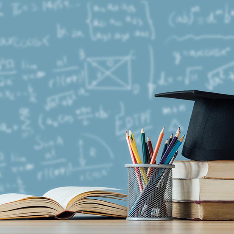 academic books in front of a chalkboard